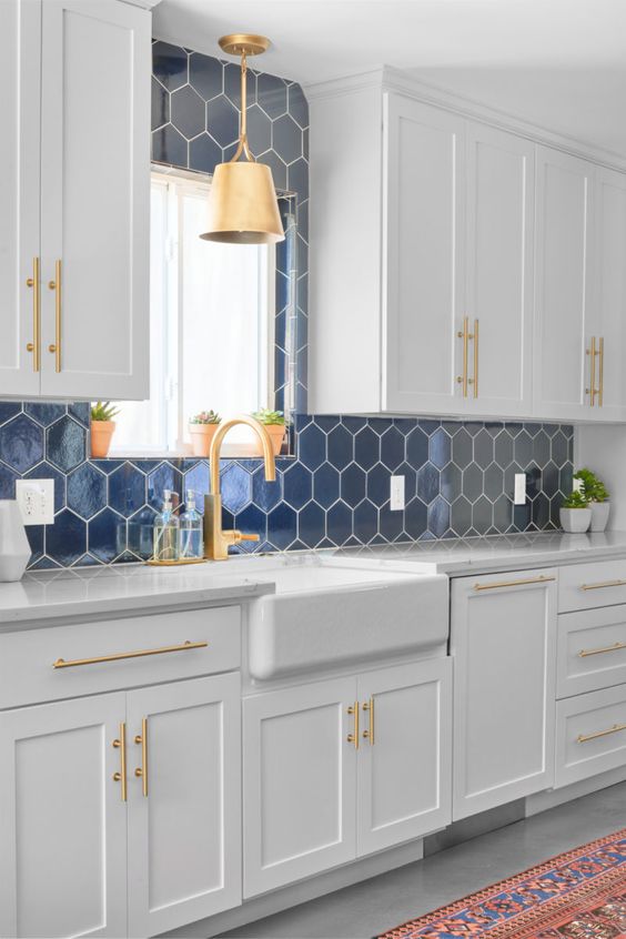 hexagonal backsplash in navy blue to create a coastal kitchen