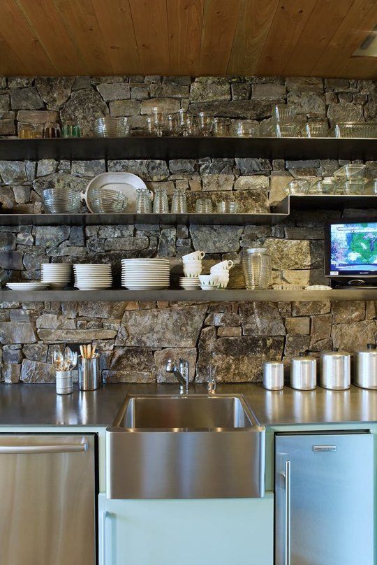 weathered stone accent wall in organic modern kitchen