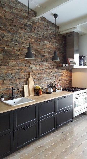 trendy modern kitchen with exposed brick wall