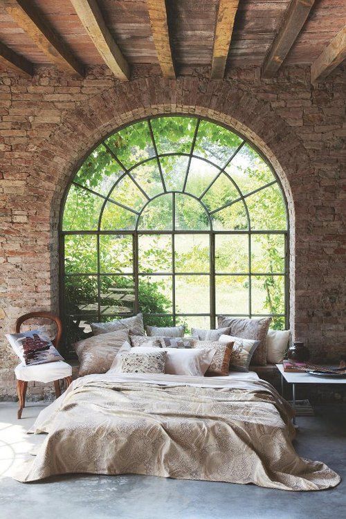 exposed brick wall italian bedroom